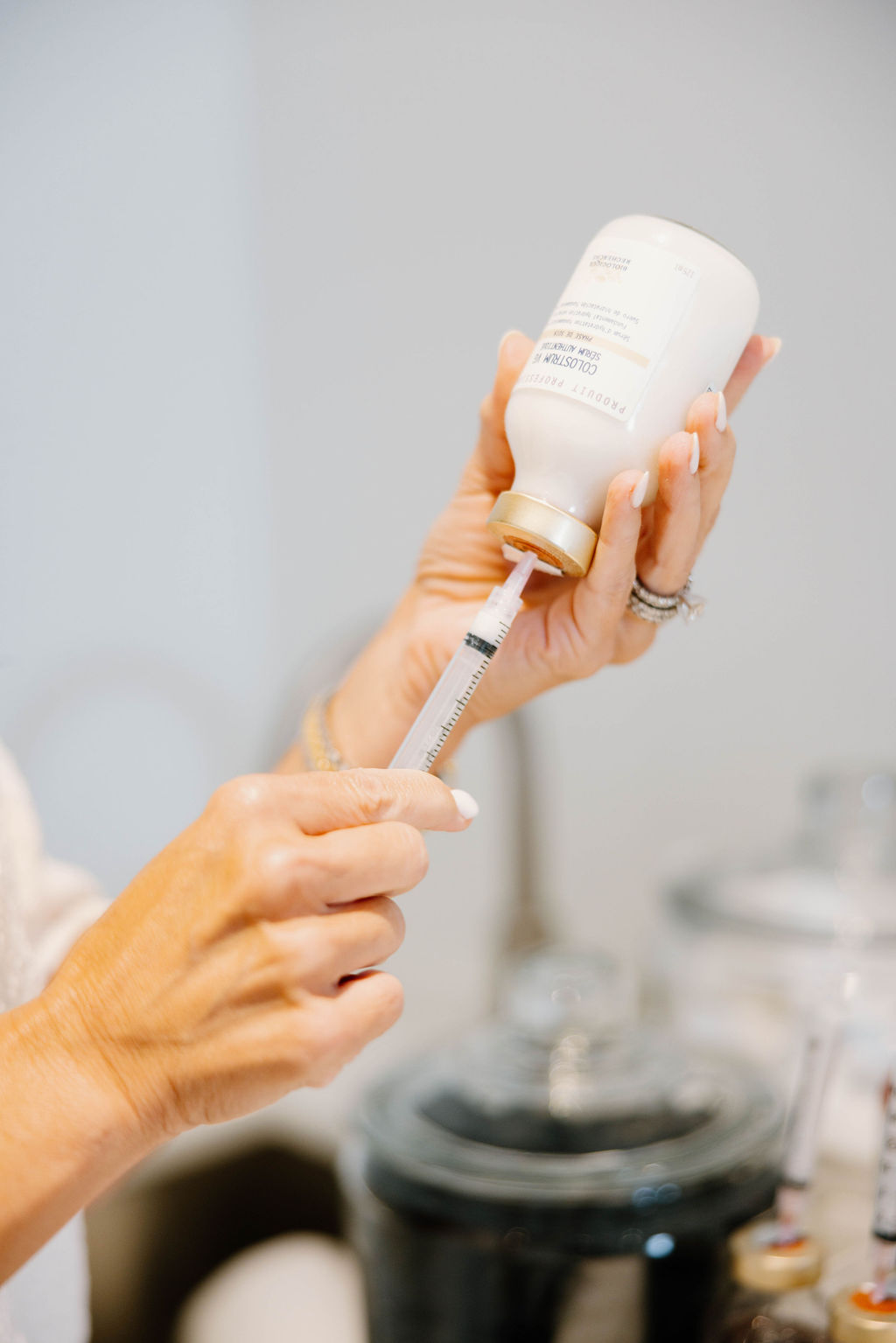 A licensed clinician preparing a facial treatment in a calm, professional clinic